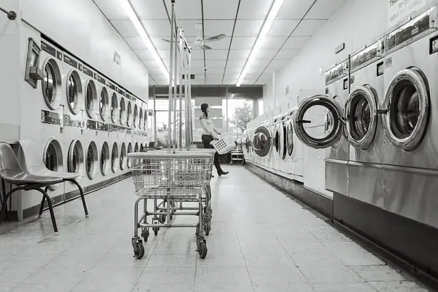 A laundromat with rows of washers / dryers