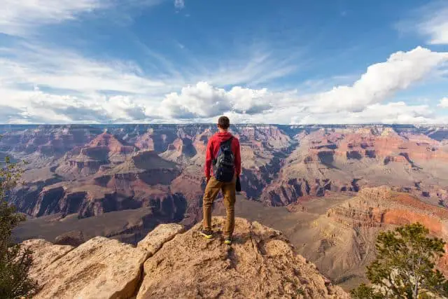 Man looking on a primitive camping trip looking at a view of Grand Canyon National Park