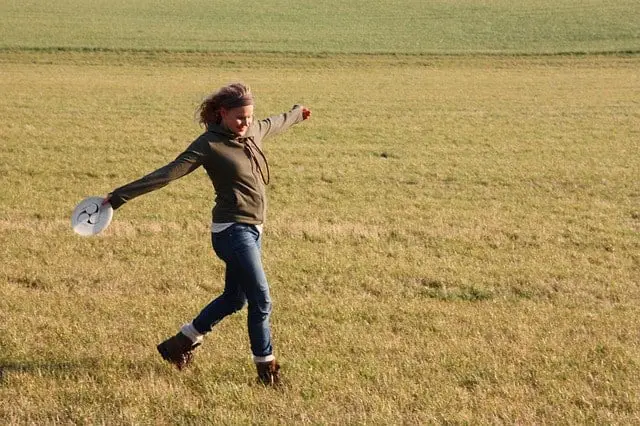 A woman playing frisbee