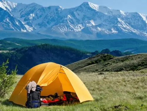 Camping tent set up near the mountains