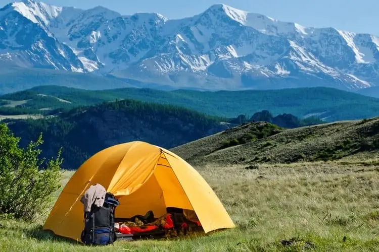 Camping tent set up near the mountains