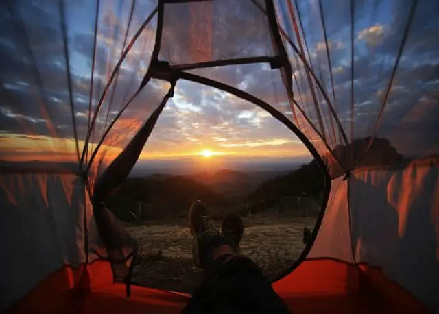 Looking at a sunset view from inside of a tent 